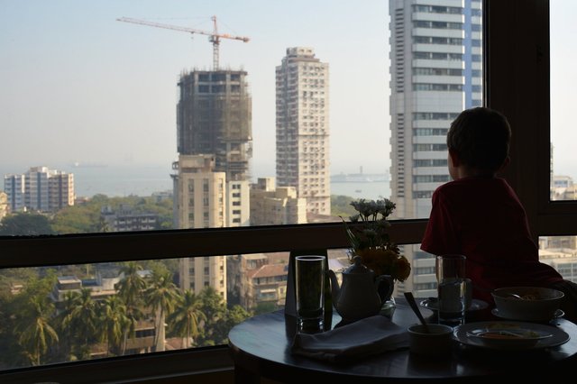 Calvin looks out the window of the Taj President in Mumbai