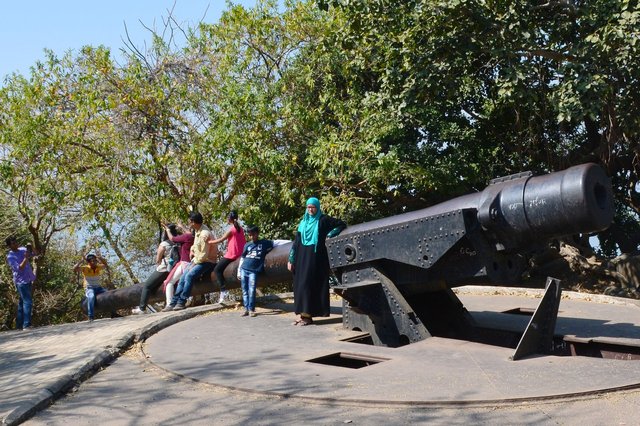 Tourists pose on a coastal defense battery on Elephanta Island