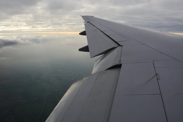 N783UA wing descending over the English countryside