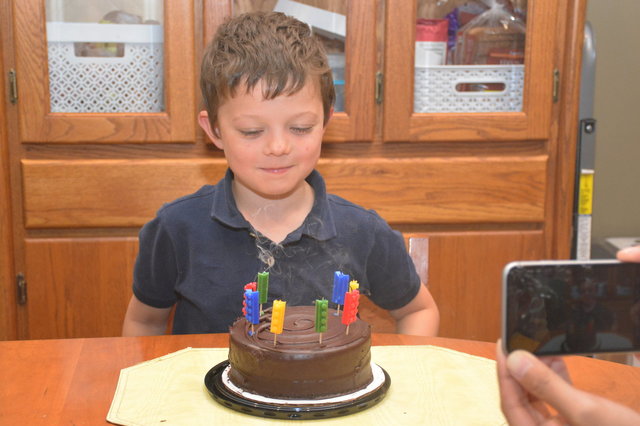 Calvin blows out his 8th birthday candles