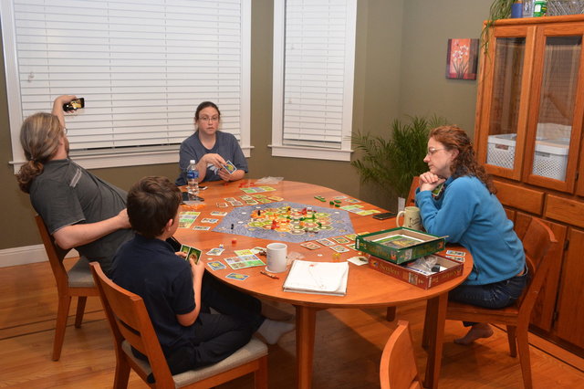 Yanthor, Anya, Calvin, and Kiesa play Cities and Knights of Catan