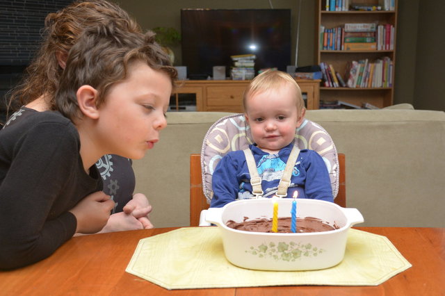 Calvin helps Julian blow out the candles on his birthday cake