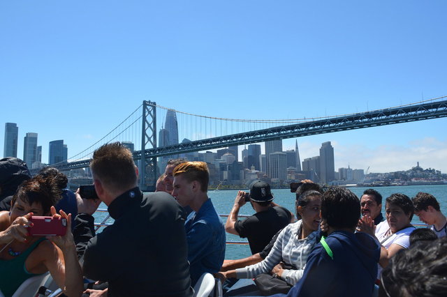 Tourists take pictures of the Bay Bridge and San Francisco from RocketBoat