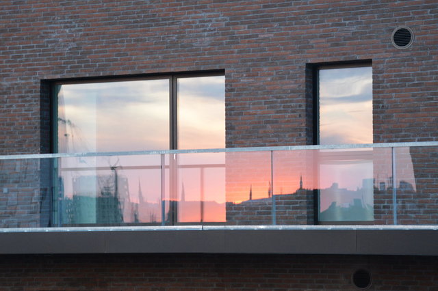 Copenhagen sunset reflected in balcony