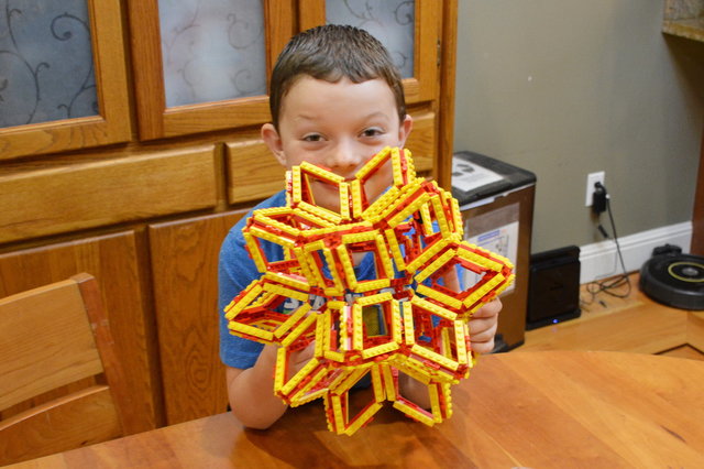 Calvin holds the assembled Lego polyhedra