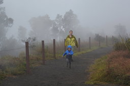 Julian runs in front of Kiesa on the Steaming Bluff above Kilauea Caldera