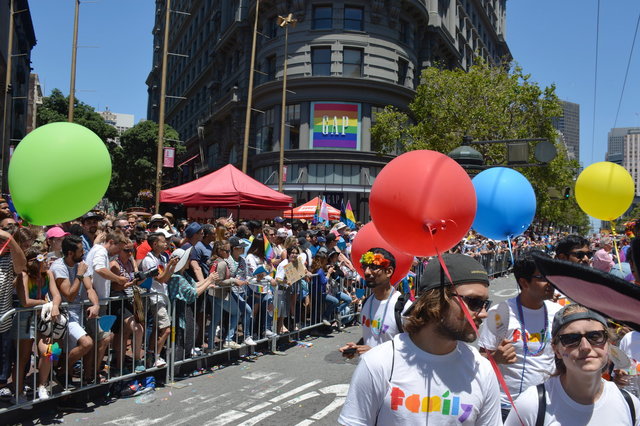 Crowd watches Googlers marching down Market Street for Pride