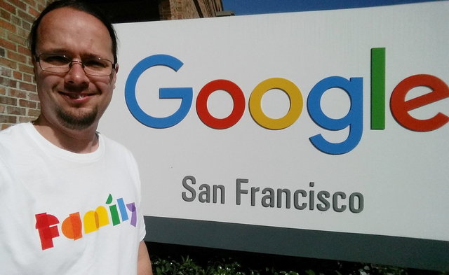 Jaeger in front of the Google San Francisco sign for Pride