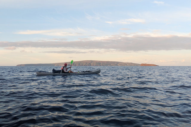 Kayak guide paddles towards Molokini Crater