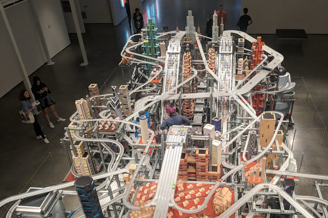 Tourists observe Metropolis II by Chris Burden at LACMA