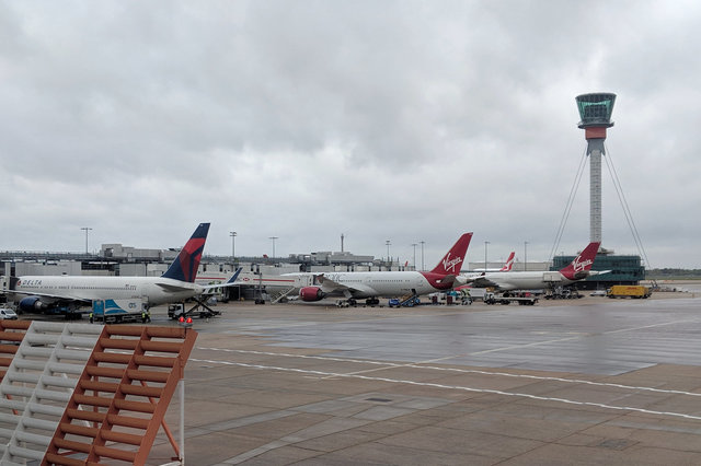 Delta and Virgin Atlantic jets lined up at Heathrow Terminal 3