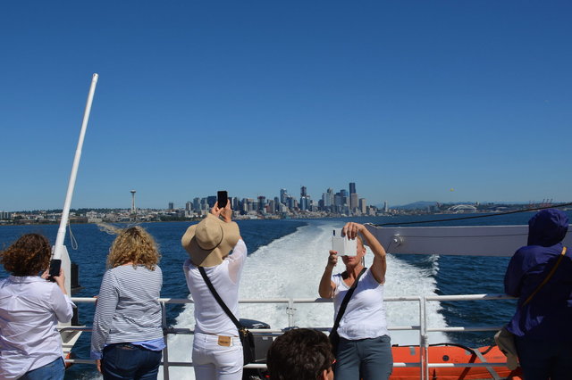 Passengers watch the Victoria Clipper V leave Seattle