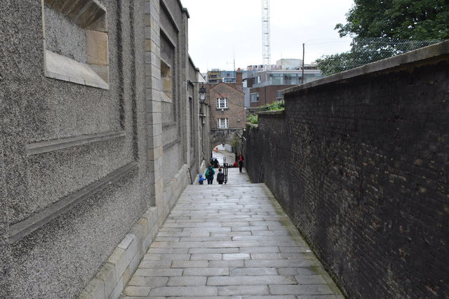 Julian, Kiesa, and Calvin walk down a walled path in Dublin