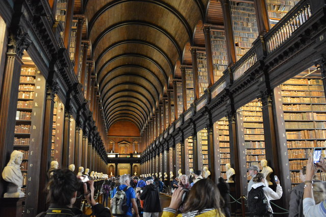 Tourists inside the Long Library at Trinity College Dublin