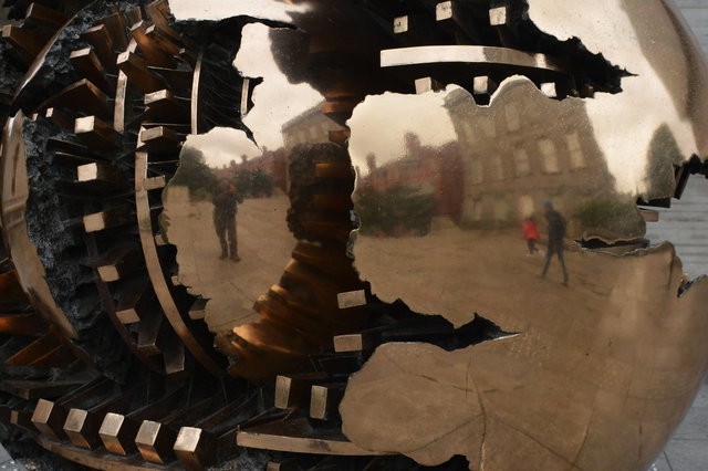 Jaeger reflected in Sphere with sphere by Arnaldo Pomodoro