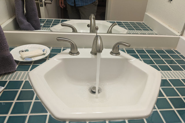 Bathroom countertop with sink running