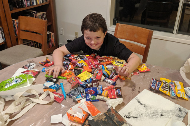 Calvin shows off his Halloween candy horde