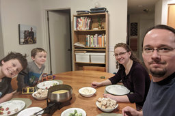 Calvin, Julian, Kiesa, and Jaeger sit down to fondue for the solstice