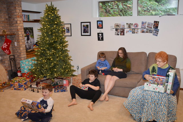 Caleb, Calvin, and Julian open Christmas presents