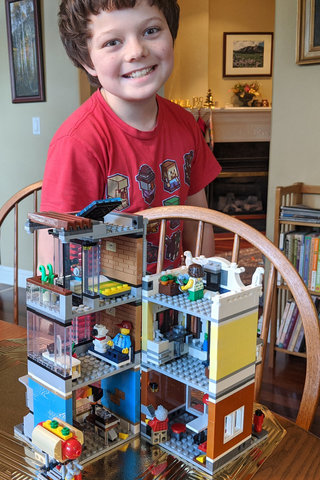 Calvin with the assembled Lego mixed-use building