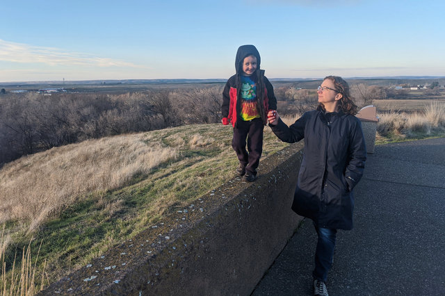 Julian walks on the wall at Whitman Mission with Kiesa