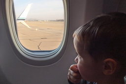 Julian looks out the window of an Alaska 737-900 at ONT