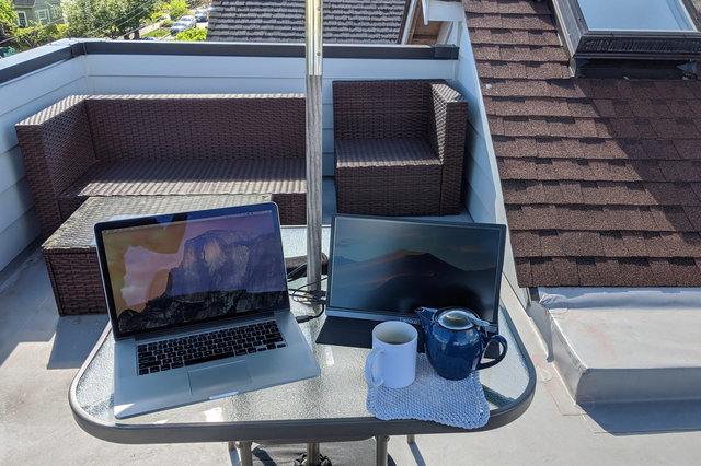 Macbook and portable monitor on roof