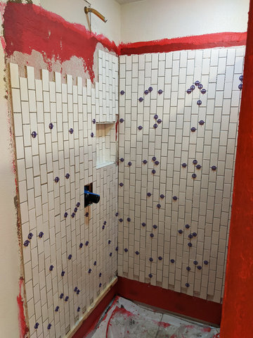 Two walls of subway tile in shower