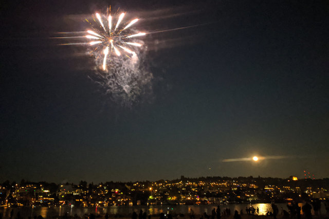 Fireworks and full moon over Lake Union