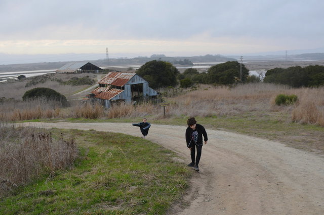 Julian and Calvin climb past the barns at Elkhorn Slough