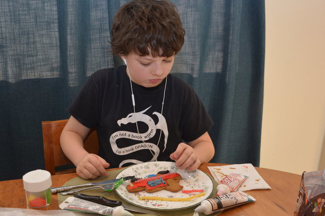 Calvin decorates a gingerbread cookie