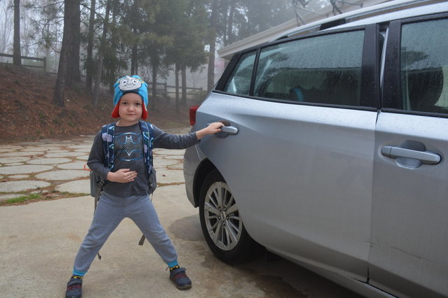 Julian gets into the car for kindergarten