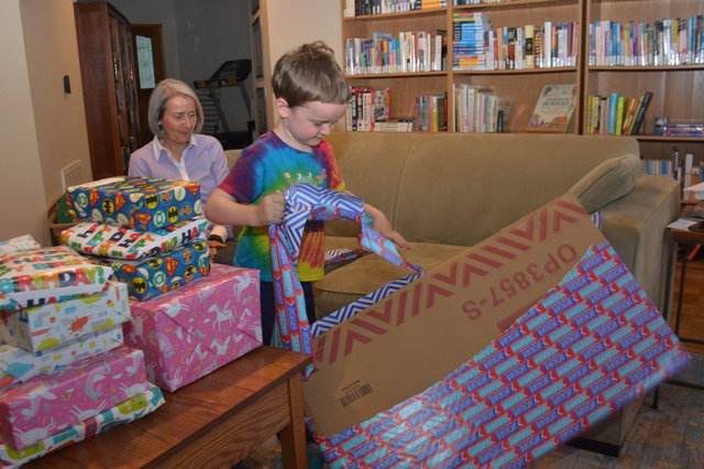 Nana watches Julian open a birthday present