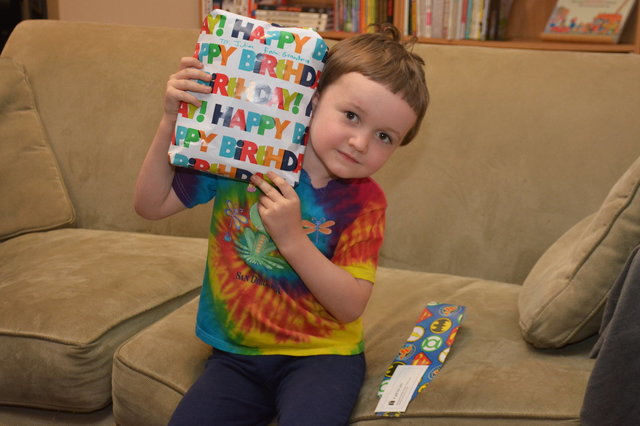 Julian poses with a wrapped birthday gift