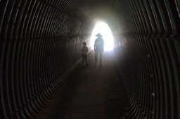Julian and Kiesa walk through the tunnel under I-80