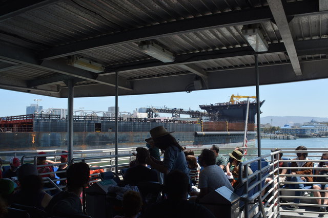 SF Bay Ferry cruises past USNS John Glenn