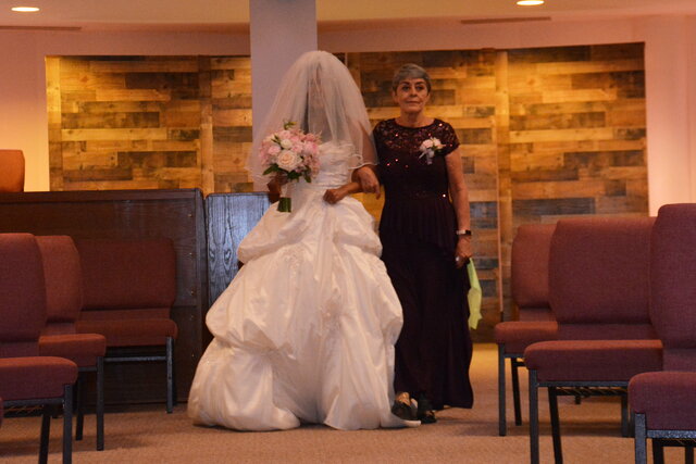 Vero's mom walks her down the aisle