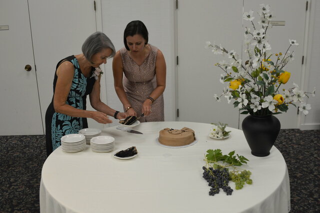 Mom and Bethany serve wedding cake