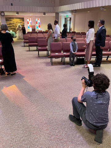 Calvin photographs Vero and her mother walking down the aisle