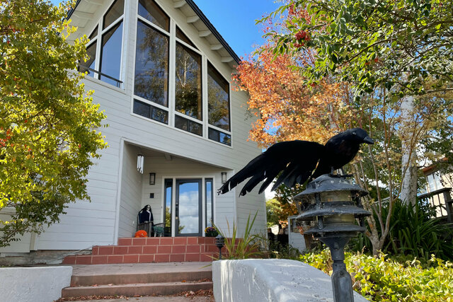 Crow guards the steps leading up to the house