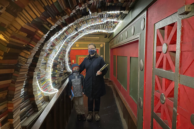 Julian and Kiesa in the book tunnel at The Last Bookstore