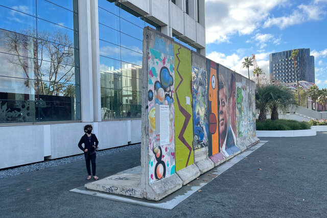 Calvin examines a section of the Berlin Wall