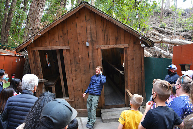 Guide leans in at Mystery Spot