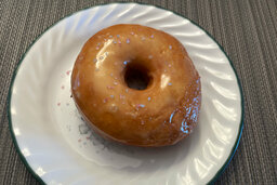 Red and white sprinkles on a doughnut