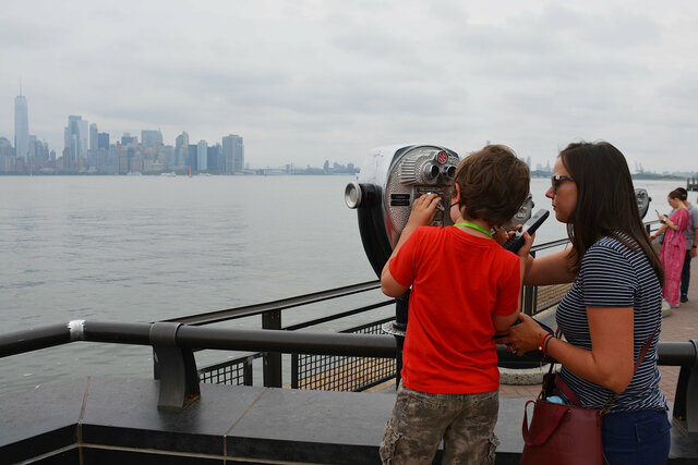 Julian and Aunt Bethany look through binoculars at Manhattan