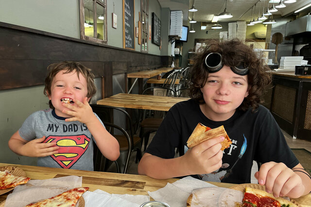 Julian and Calvin eat pizza in Brooklyn