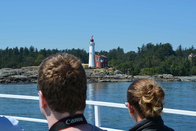 Whale watching boat passes Fisgard Lighthouse