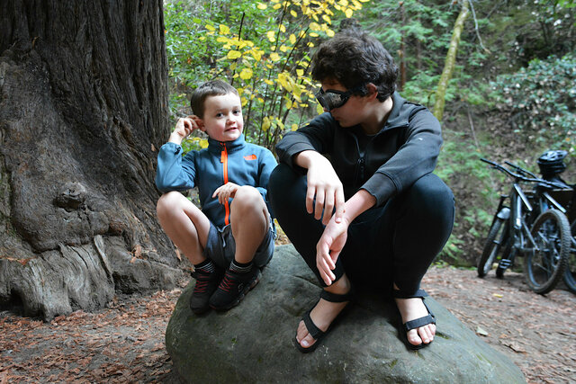 Julian and Calvin wait on a rock