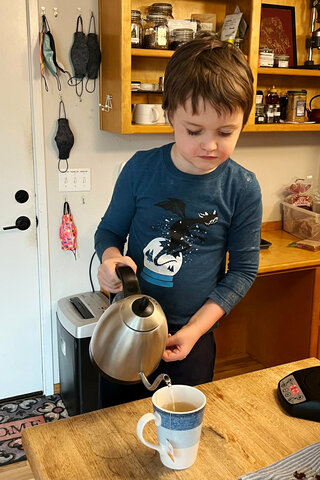 Julian pours water for tea