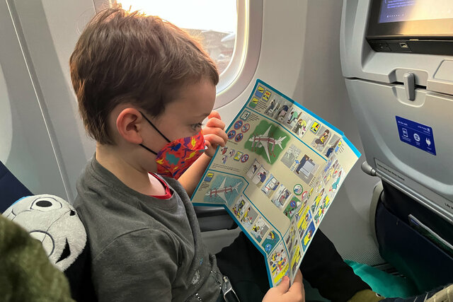 Julian reviews the safety information card for this 787-9 aircraft